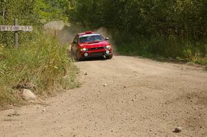 Bob Olson / Ryan Johnson prepare for a hard 90-left on SS9 in their Subaru Impreza.