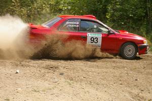 Bob Olson / Ryan Johnson drift through a 90-left on SS9 in their Subaru Impreza.