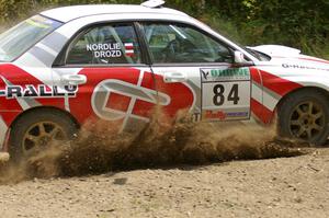 Greg Drozd / John Nordlie sling gravel as they power through a left-hander on SS9 in their Subaru WRX.