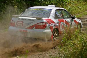 Greg Drozd / John Nordlie power out of a left-hander on SS9 in their Subaru WRX.