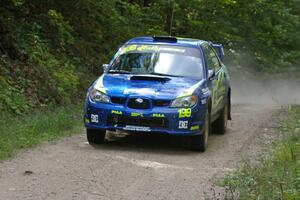 Travis Pastrana / Christian Edstrom Subaru WRX STi takes it easy and get no air over the jump on SS13.