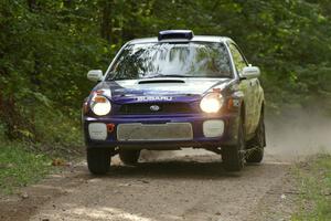 Tanner Foust / Chrissie Beavis Subaru WRX gets ever so light over the jump on SS13.