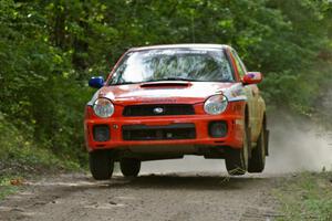 Matthew Johnson / Kim DeMotte Subaru WRX catches decent air on the jump on SS13.