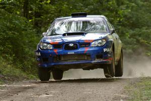 Otis Dimiters / Alan Ockwell catch manor air at the yump on SS13 in their Subaru WRX STi.