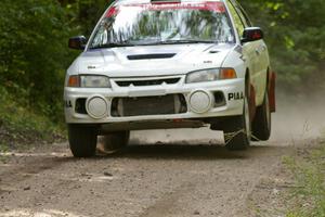 Chris Gilligan / Joe Petersen catch minimal air in their Mitsubishi Lancer Evo IV at the jump on SS13.