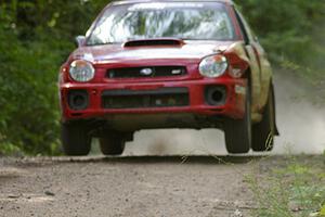 Dave Anton / Dominik Jozwiak caught decent air on the jump on SS13 in their Subaru WRX STi.
