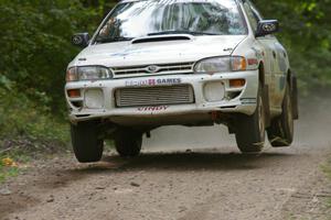 Henry Krolikowski / Cindy Krolikowski catch some decent air in their Subaru WRX at the jump on SS13.