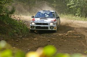 Dave Hintz / Rick Hintz drift through a tight at a right-hander on SS13 in their Subaru WRX.