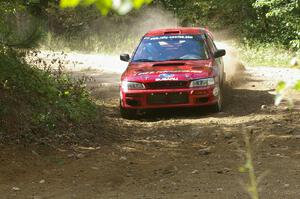 Erik Schmidt / Mike Rose drift through a right-hander on SS13 in their Subaru Impreza.