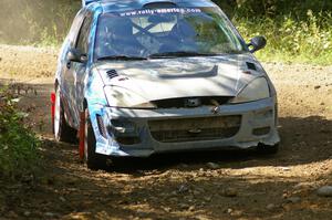 Adam Boullion / Phil Boullion Ford Focus at an uphill right-hander on SS13.