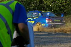Travis Pastrana / Christian Edstrom Subaru WRX STi comes out of the woods and onto the county road on SS14.