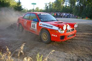 Matthew Johnson / Kim DeMotte drift past the assembled crowd on SS14 in their Subaru WRX.