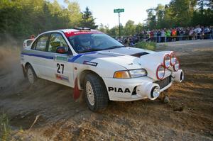 Chris Gilligan / Joe Petersen drift past the massive crowd on SS14 in their Mitsubishi Lancer Evo IV.