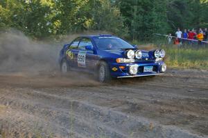 Kyle Sarasin / Stuart Sarasin drift through a 90-right at the SS14 spectator point in their Subaru Impreza.