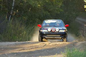 Scott Justus / Dave Parps come out of the woods and onto the county road on SS14 in their Nissan Sentra SE-R.