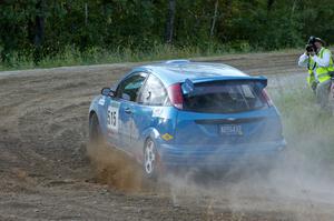 Photographer Ronnie Arnold snaps a shot of Adam Boullion / Phil Boullion Ford Focus at the spectator point on SS14.