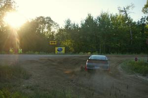 Erick Nelson / Greg Messler go onto the county road at the spectator point on SS14 in their Plymouth Laser.