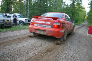 Matthew Johnson / Kim DeMotte release the clutch and let the dirt fly at the start of SS16 in their Subaru WRX.