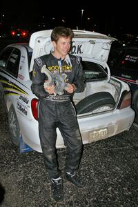 Tanner Foust displays the wheel that he destroyed after hitting a large rock at speed on SS16 (2).