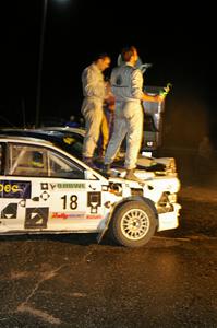 Matt Iorio and Ole Holter stand atop their second place Subaru Impreza after the champagne spray.