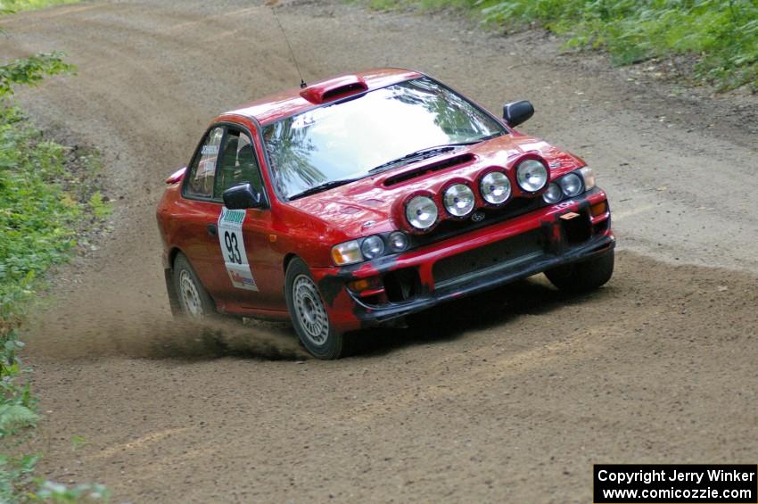 Bob Olson / Ryan Johnson drift through a fast left on SS2 in their Subaru Impreza.