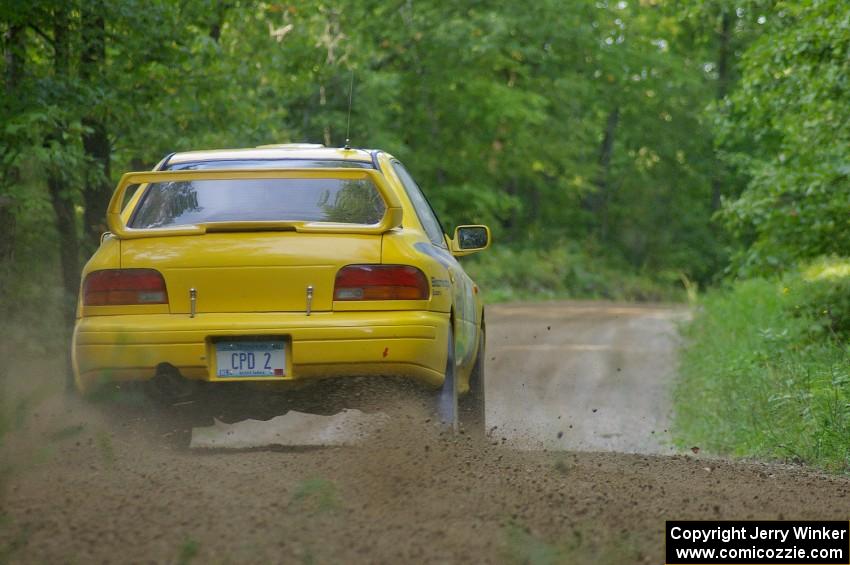 Mike Hurst / Russ Norton Subaru Impreza crests a hill near the finish of SS2.