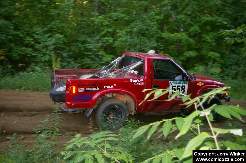 Jim Cox / Chris Stark power out of a hairpin on SS3 in their Chevy S-10.