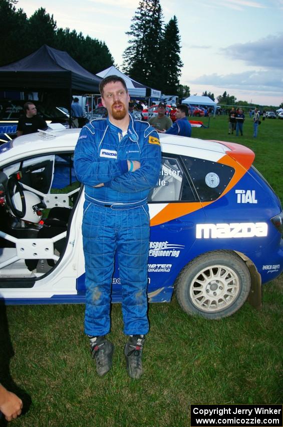 Eric Burmeister stands next to his Mazda Mazdaspeed 3 that he and Dave Shindle had a transmission go out on in the early stages.