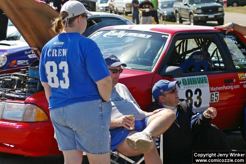 Mary Utecht, Mark Utecht, and Mike Hurst take a breather in front of Mark's Ford Mustang at parc expose.