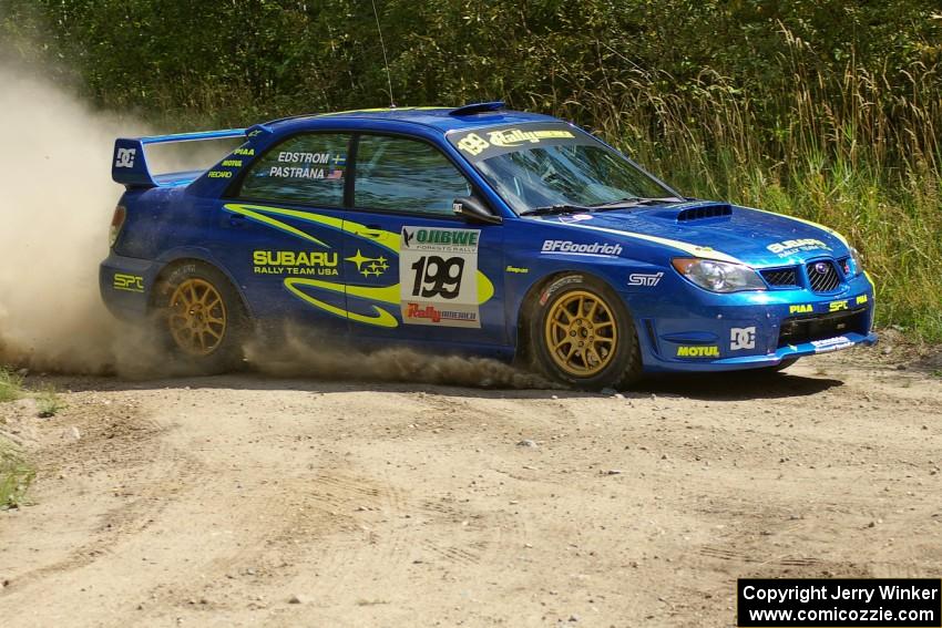 Travis Pastrana / Christian Edstrom Subaru WRX STi slings gravel at a hard left-hander on SS9.