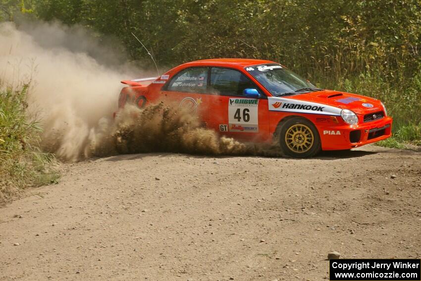 Matthew Johnson / Kim DeMotte Subaru WRX slings gravel at a 90-left on SS9.