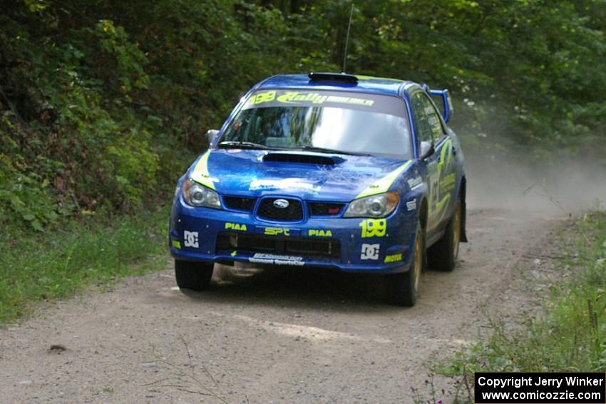 Travis Pastrana / Christian Edstrom Subaru WRX STi takes it easy and get no air over the jump on SS13.