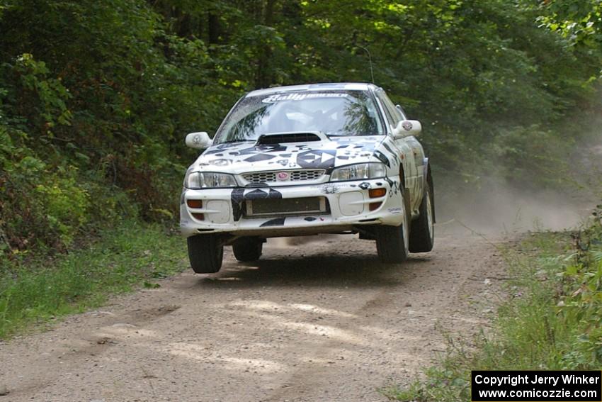 Matt Iorio / Ole Holter get a mild amount of air in their Subaru Impreza over the jump on SS13.