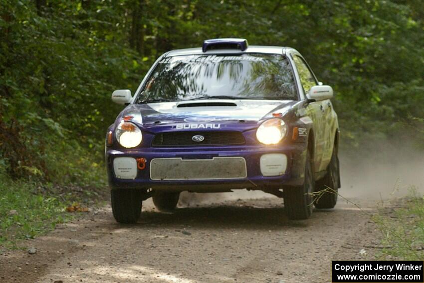Tanner Foust / Chrissie Beavis Subaru WRX gets ever so light over the jump on SS13.