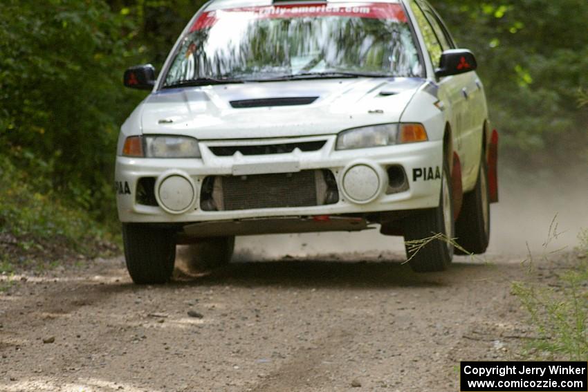 Chris Gilligan / Joe Petersen catch minimal air in their Mitsubishi Lancer Evo IV at the jump on SS13.