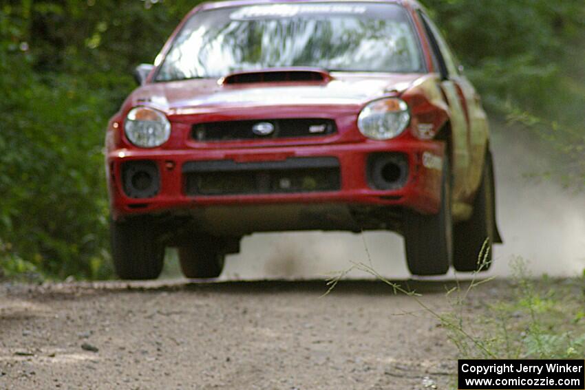 Dave Anton / Dominik Jozwiak caught decent air on the jump on SS13 in their Subaru WRX STi.