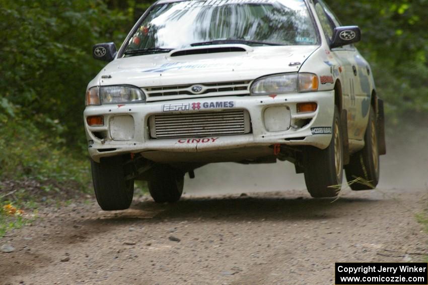 Henry Krolikowski / Cindy Krolikowski catch some decent air in their Subaru WRX at the jump on SS13.