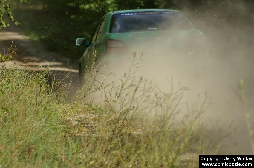 Eric Langbein / Jeremy Wimpey Subaru WRX speed away down the straight after the jump on SS13.