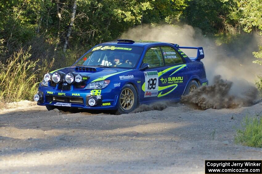 Travis Pastrana / Christian Edstrom Subaru WRX STi comes out of the woods and onto the county road on SS14.