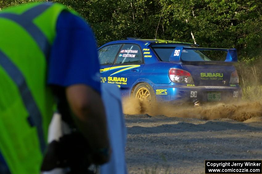 Travis Pastrana / Christian Edstrom Subaru WRX STi comes out of the woods and onto the county road on SS14.