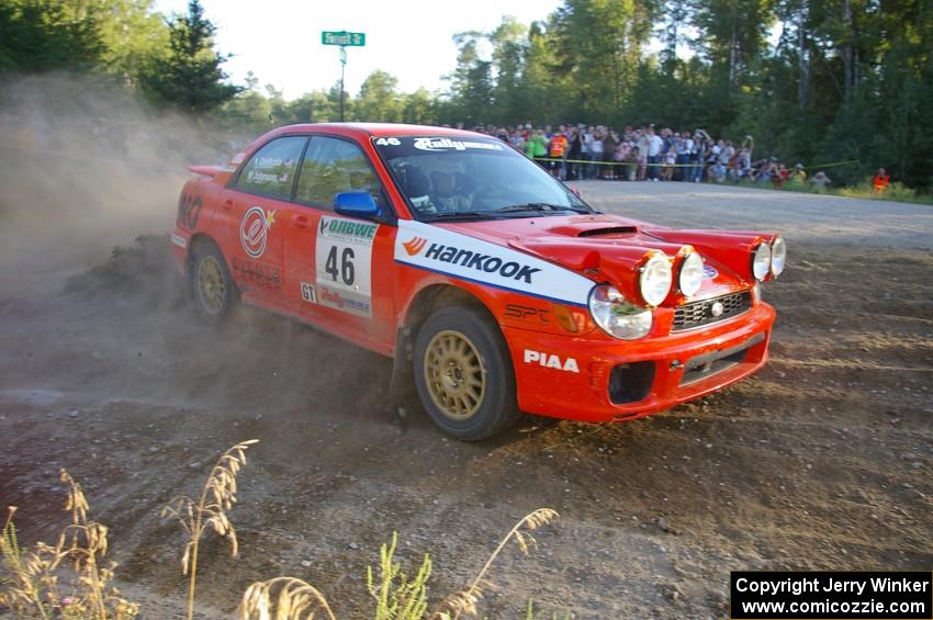 Matthew Johnson / Kim DeMotte drift past the assembled crowd on SS14 in their Subaru WRX.