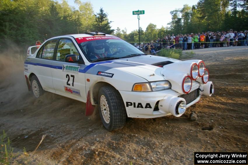 Chris Gilligan / Joe Petersen drift past the massive crowd on SS14 in their Mitsubishi Lancer Evo IV.