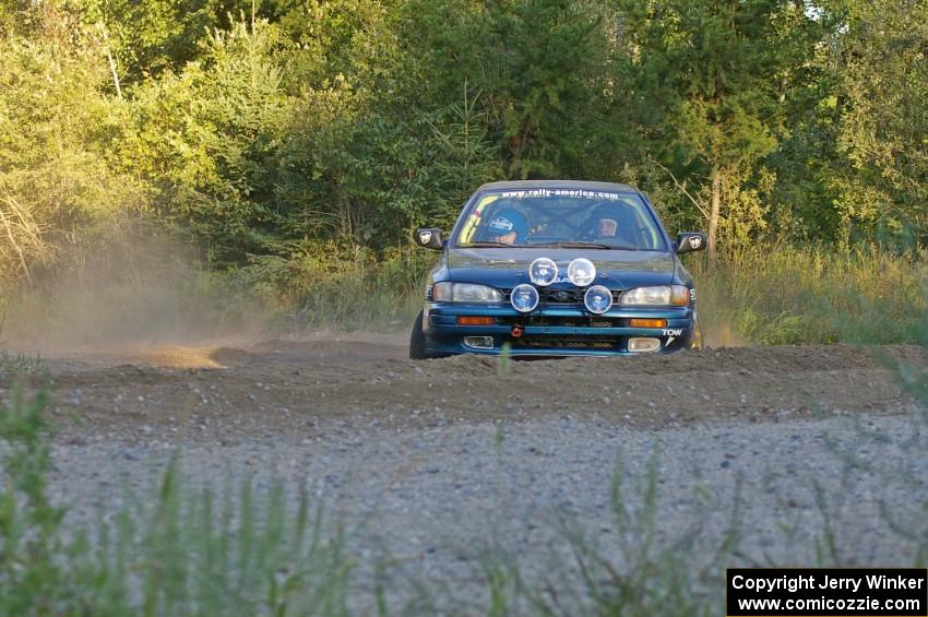 Martin Menning / Ryan Schnell come onto the county road in their Subaru Impreza at the spectator point on SS14.