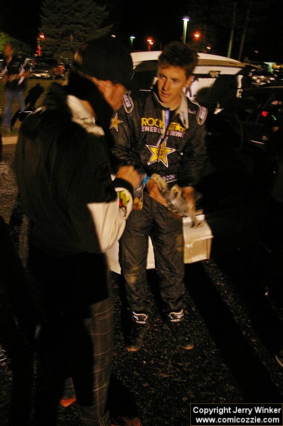 Tanner Foust shows his wheel that he destroyed to Matthew Johnson. Tanner hit a large rock at speed on the second to last stage.