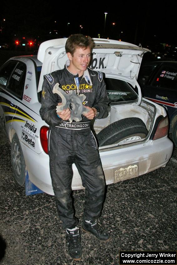 Tanner Foust displays the wheel that he destroyed after hitting a large rock at speed on SS16 (2).