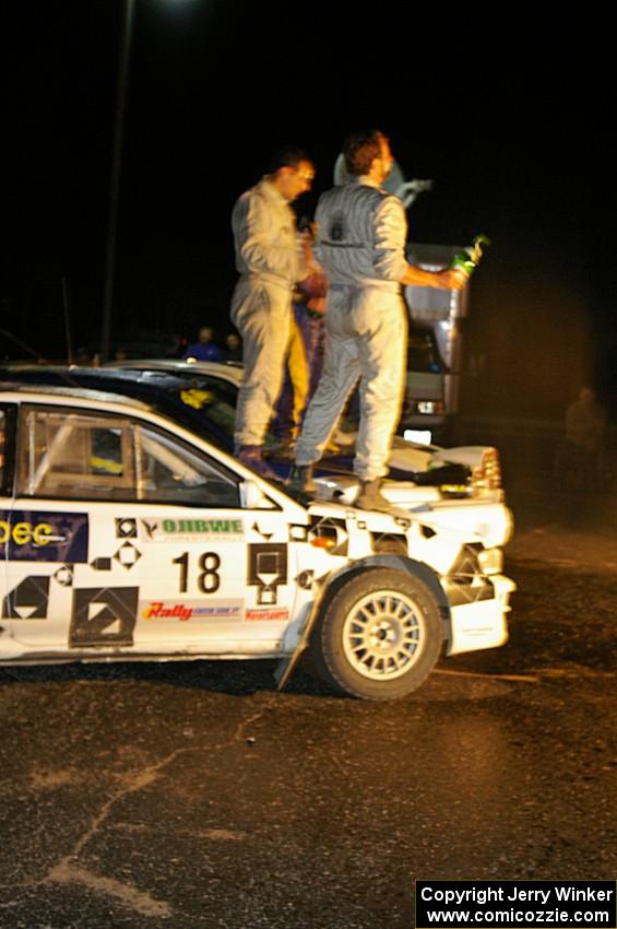 Matt Iorio and Ole Holter stand atop their second place Subaru Impreza after the champagne spray.