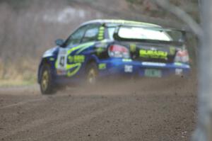 Ken Block / Alex Gelsomino drift at a hard left near the start SS1 in their Subaru WRX STi.