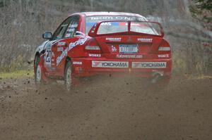 Andrew Comrie-Picard / Marc Goldfarb sling gravel at a fast left-hander on SS1 in their Mitsubishi Lancer Evo IV.