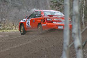 Matthew Johnson / Kim DeMotte hang the tail out on their Subaru WRX at the first tight left hander on SS1.