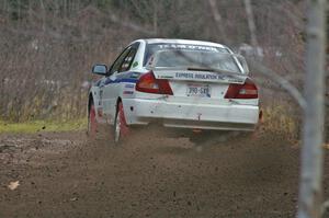 Chris Gilligan / Joe Petersen sling gravel far in their Mitsubishi Lancer Evo IV on Herman, SS1.